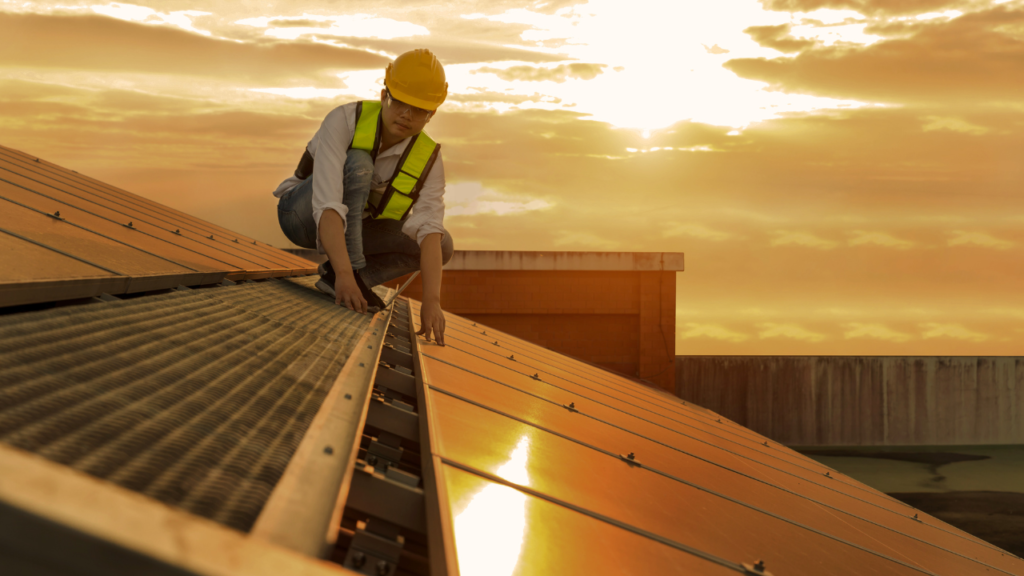 man on solar roof installing solar panels
